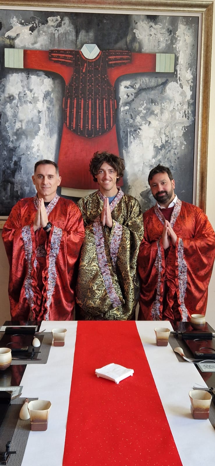 Tre amici in abiti tradizionali a tavola